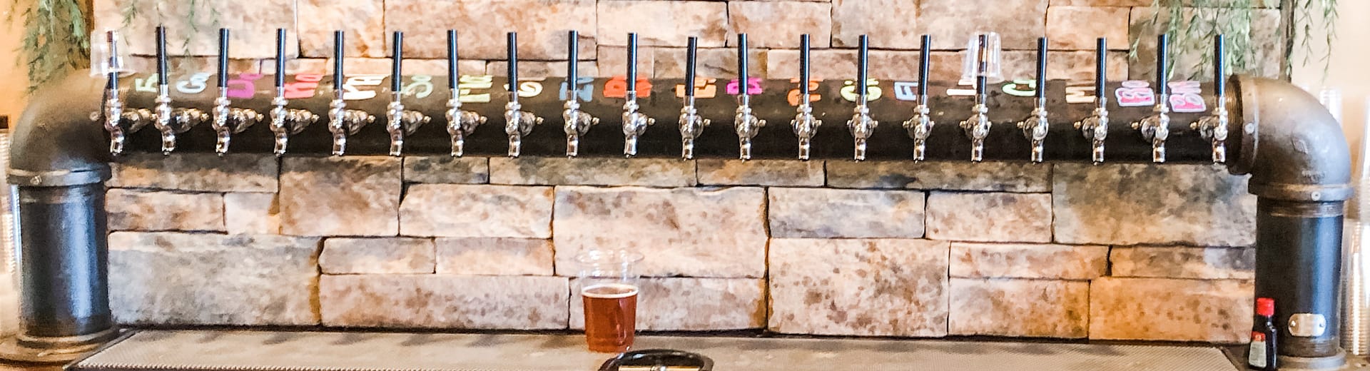 Fifteen tap handles with stone in background