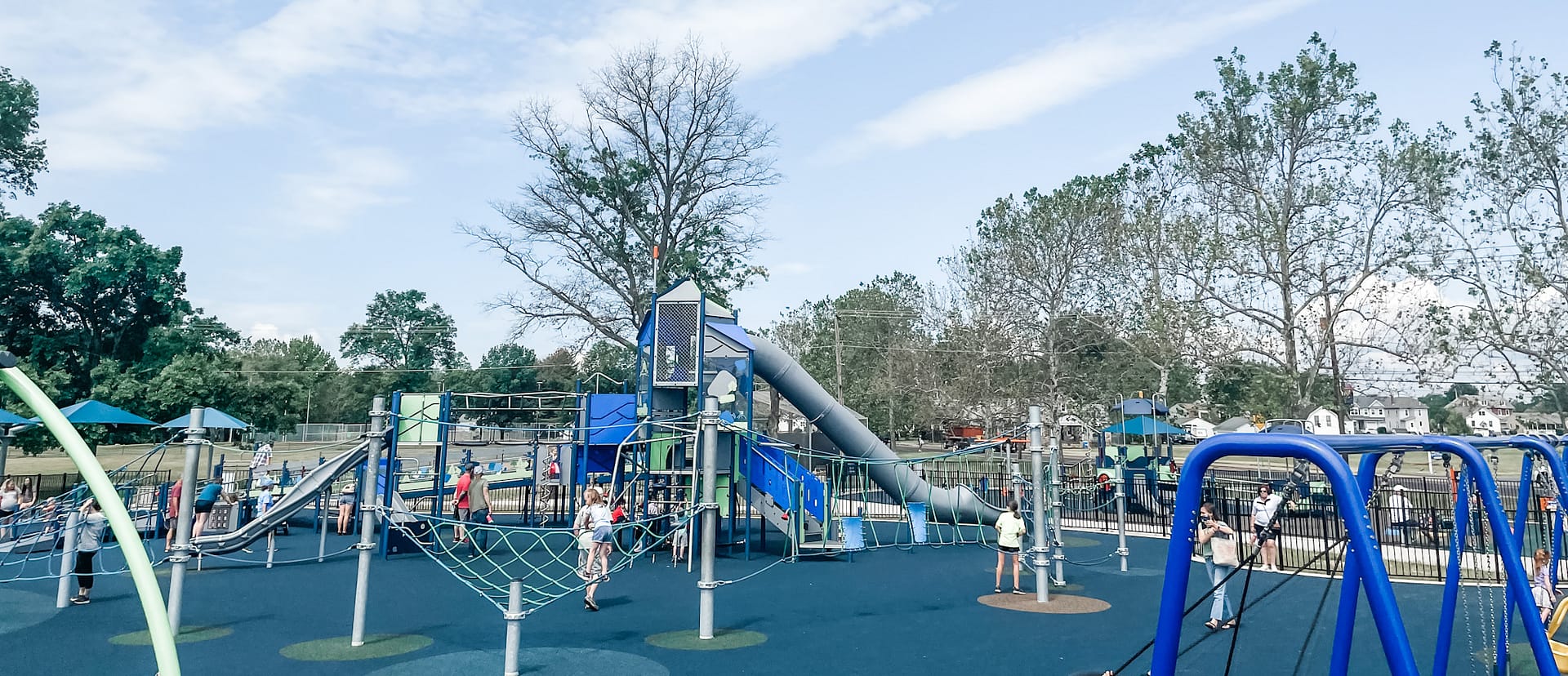 Playground structure with long gray slide