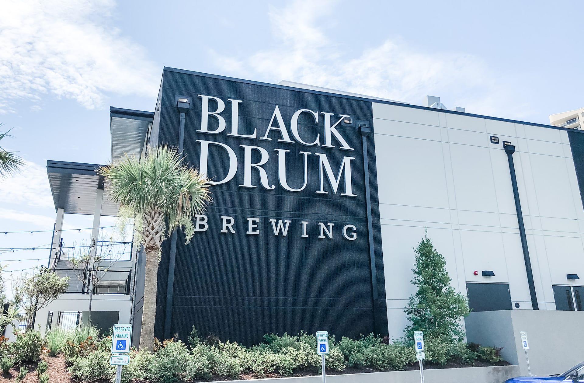 Black sign on building that reads Black Drum Brewing