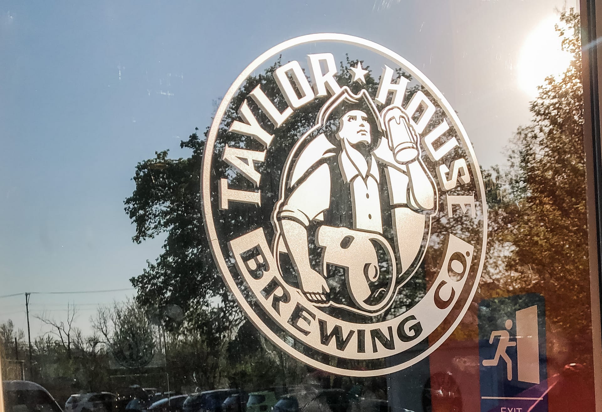 Logo on window that reads Taylor House Brewing Co.