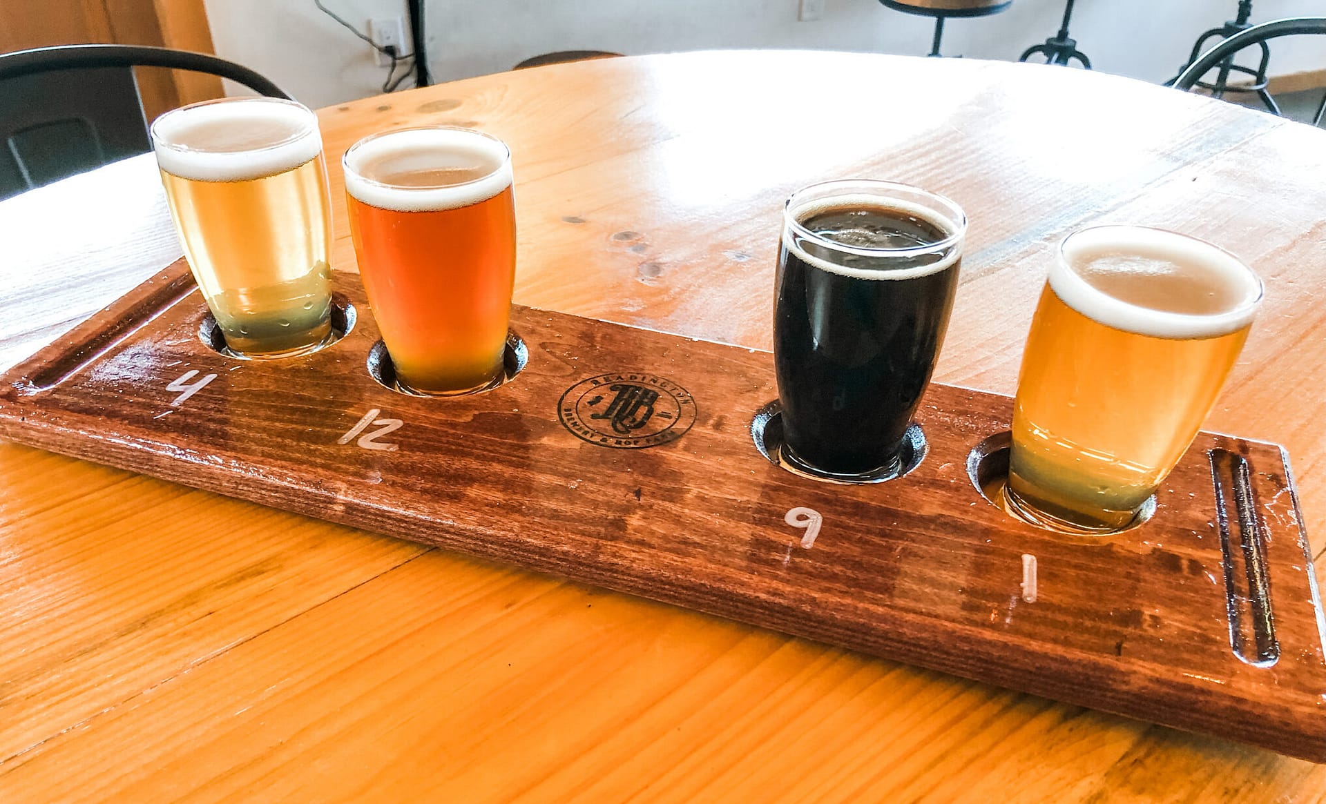 Four beer flight with wood table in background