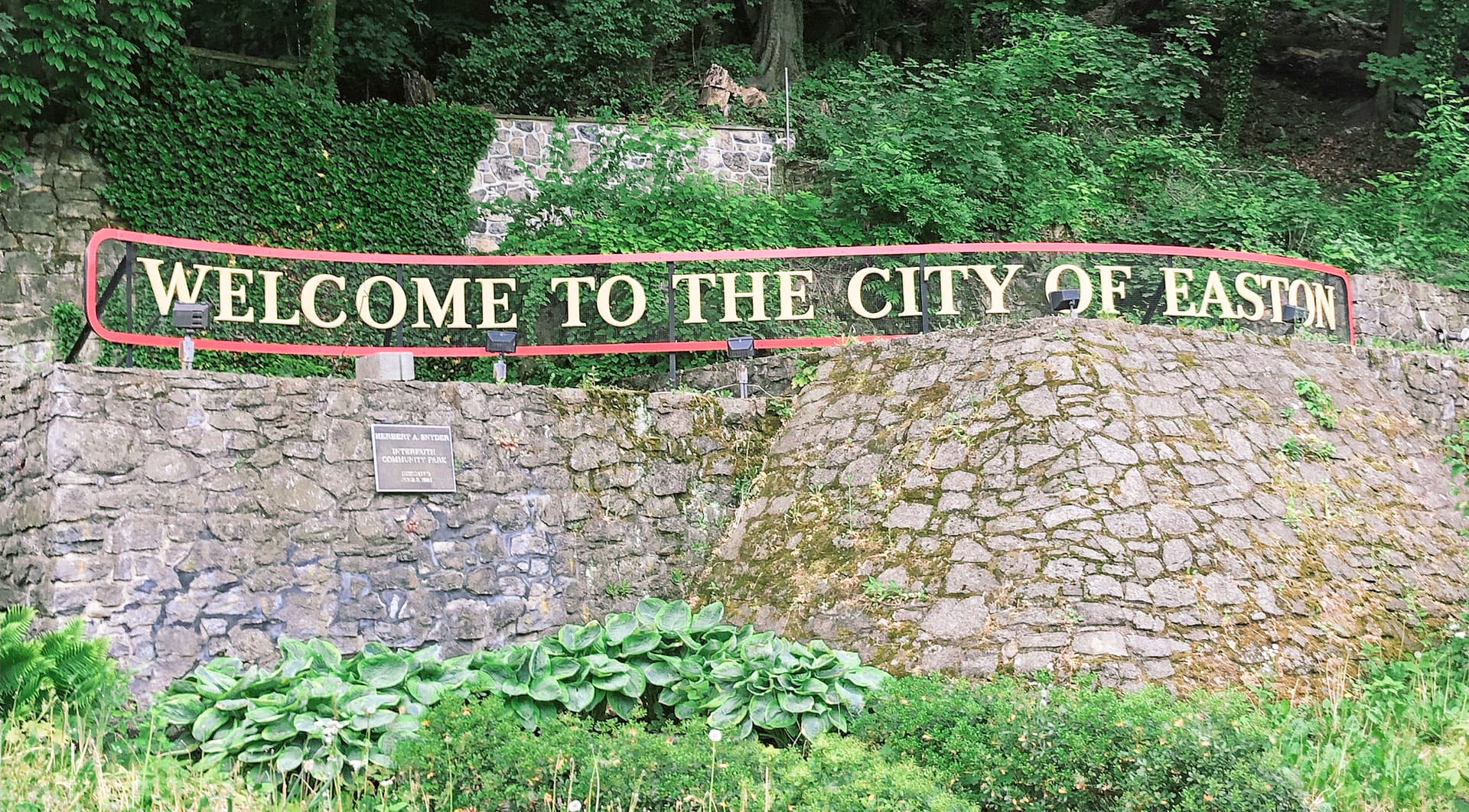 Sign that reads Welcome to the City of Easton with wooded area in background